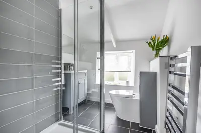 a bathroom with a shower and a toilet and a sink at Traditional coastal cottage in Cornwall in Saint Teath