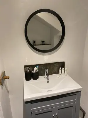 a bathroom with a sink and a mirror at Traditional coastal cottage in Cornwall in Saint Teath