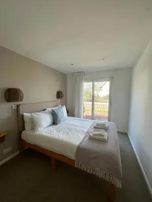 a bedroom with a large bed with a window at Beach house with expansive sea views! in Newquay