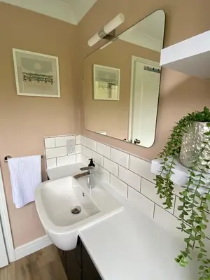 a bathroom with a white sink and a mirror at About Time Meva - stylish two-bedroom, dog-friendly home-from-home with parking and garden in Mevagissey