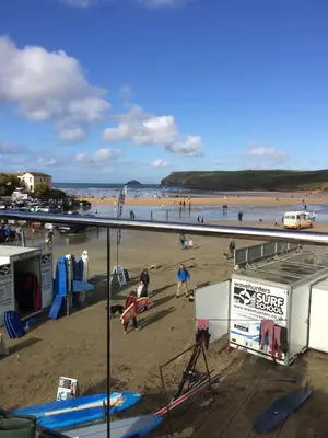 a beach with a bunch of people on the sand at Singing Cottage in Port Isaac