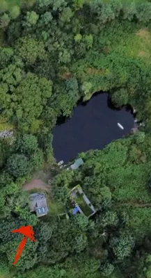an aerial view of a house and a lake at Tresahor Studio with sauna in Falmouth