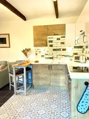 a kitchen with a table and a counter top at The Cowshed - Cottage in Cornwall in Jacobstow