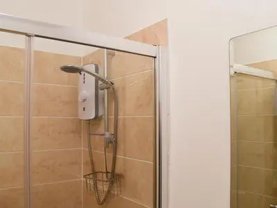 a shower with a shower head in a bathroom at Madderhay - Uk43512 in Lostwithiel