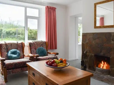 a living room with a bowl of fruit on a table at Madderhay - Uk43512 in Lostwithiel
