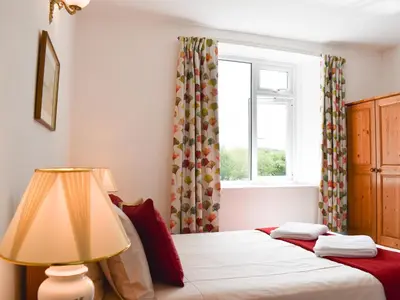 a bedroom with two beds and a window at Madderhay - Uk43512 in Lostwithiel
