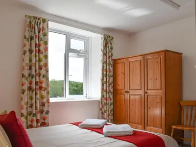 a bedroom with a bed and a window at Madderhay - Uk43512 in Lostwithiel