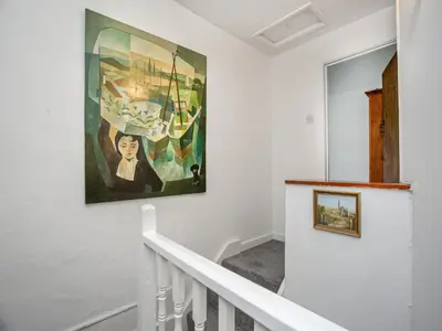 a staircase with a painting on the wall at Carneggo in Saint Dennis