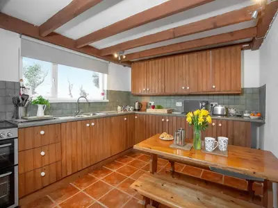 a kitchen with wooden cabinets and a wooden table at Carneggo in Saint Dennis