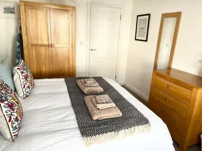 a bedroom with a bed with two towels on it at Seascape Stay No 4, Sea View & Parking in Falmouth