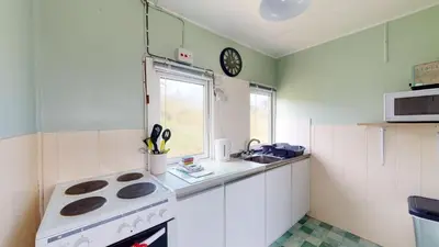 a small kitchen with a stove and a sink at E04 Fresno, Riviere Towans in Hayle