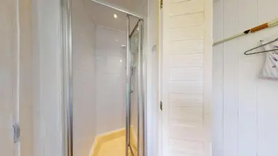 a shower with a glass door in a bathroom at E04 Fresno, Riviere Towans in Hayle