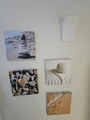 a wall with pictures of rocks on it at End Cottage Veryan Cornwall in Truro