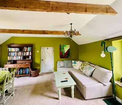 a living room with a couch and a table at Exceptional retreat near Cornwall Coast in Tywardreath