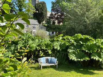 a bench sitting in the middle of a garden at Exceptional retreat near Cornwall Coast in Tywardreath