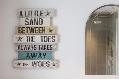 a sign that reads a little sand between the toes always takesaway the toes at Charming Cornish Cottage in the heart of St Agnes in St. Agnes
