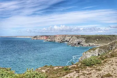 a view of a body of water with rocks at Charming Cornish Cottage in the heart of St Agnes in St. Agnes