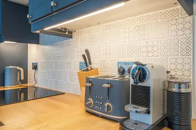 a kitchen with a blue appliance in a room at Charming Cornish Cottage in the heart of St Agnes in St. Agnes
