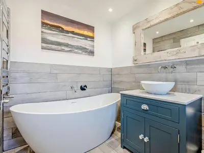 a bathroom with a white tub and a sink at 3 Bed in Newquay oc-47630 in Newquay