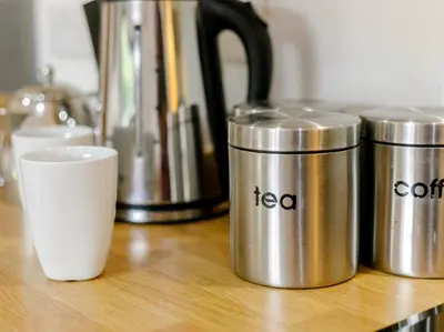 a group of metal cups sitting on a wooden table at 1 Bed in Callington oc-54344 in Linkinhorne