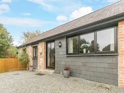 a brick house with windows on the side of it at 1 Bed in Callington oc-54344 in Linkinhorne