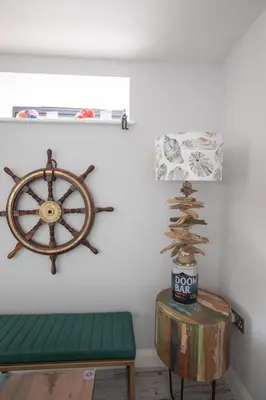 a room with a bench and a steering wheel on a wall at UPPER BEACH HOUSE in Portreath