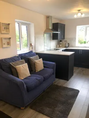 a living room with a blue couch in a kitchen at The Artists Barn in Launceston
