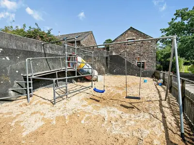 a playground with a slide in the sand at 2 Bed in Launceston oc-02043 in North Petherwin