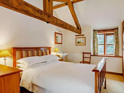 a bedroom with a large white bed and a desk at 2 Bed in Launceston oc-02036 in North Petherwin