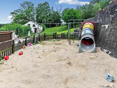 a playground with a water slide in the sand at 2 Bed in Launceston oc-02036 in North Petherwin