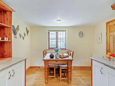 a kitchen with a table and chairs in a room at 2 Bed in Callington oc-kates in North Hill