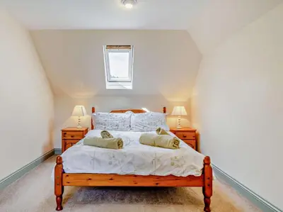 a bedroom with a large bed with two night stands at 2 Bed in Callington oc-kates in North Hill