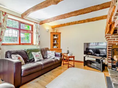 a living room with a leather couch and a fireplace at 2 Bed in Callington oc-kates in North Hill