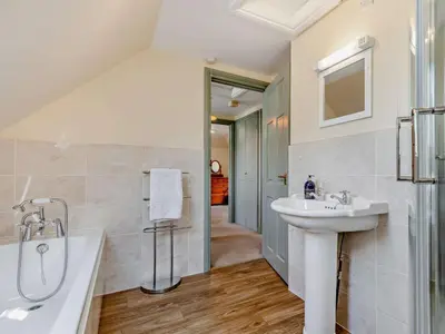 a white bathroom with a sink and a tub and a sinkonnaissance at 2 Bed in Callington oc-kates in North Hill