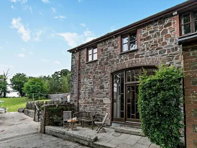 a brick house with a patio in front of it at 2 Bed in Launceston oc-02038 in North Petherwin