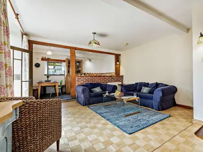 a living room with blue couches and a table at 2 Bed in Launceston oc-02038 in North Petherwin