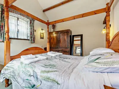 a bedroom with a large bed with two pillows at 2 Bed in Launceston oc-02033 in North Petherwin