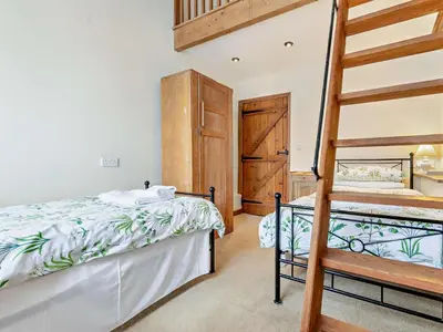 a bedroom with a bunk bed and a ladder at 2 Bed in Launceston oc-02033 in North Petherwin