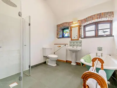 a bathroom with a tub and a toilet and a sink at 2 Bed in Launceston oc-02033 in North Petherwin