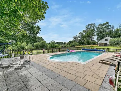 a swimming pool with chairs and a fence at 2 Bed in Launceston oc-02033 in North Petherwin