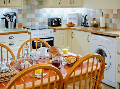 a kitchen with a table with bread and orange juice at 2 Bed in Callington oc-tyler in North Hill
