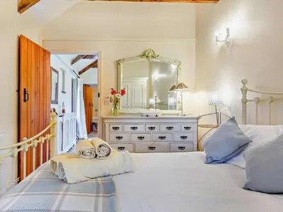 a bedroom with a bed with a sink and a mirror at 2 Bed in Callington oc-tyler in North Hill
