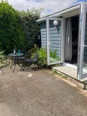 a table and chair sitting outside of a house at Praa Sands - Apartment - Sleeps 2 - Parking in Praa Sands