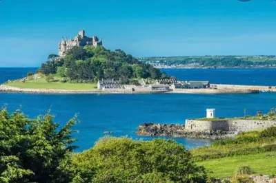 an island with a castle in the middle of a body of water at Praa Sands - Apartment - Sleeps 2 - Parking in Praa Sands
