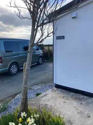a van parked in a parking lot next to a tree at Praa Sands - Apartment - Sleeps 2 - Parking in Praa Sands