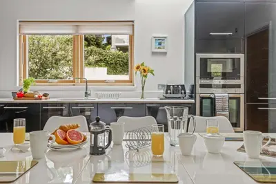 a kitchen with a table with fruit on it at House 12 in Looe