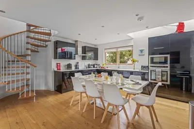 a kitchen and dining room with a table and chairs at House 12 in Looe