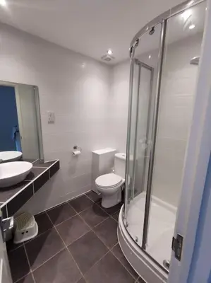 a bathroom with a shower and a toilet and a sink at Cornwall Holiday Home, Casa Da Praia in Saint Columb Major
