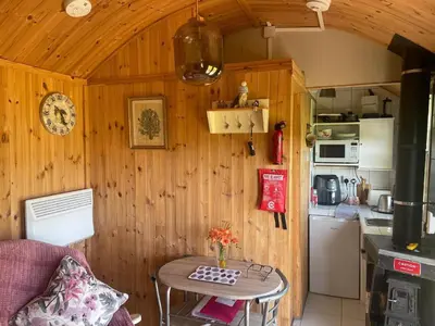 a small kitchen with a small table in a room at 1 Bedroom Cabin Sleeps 2 Private Garden WiFi in Camelford
