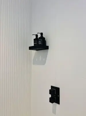 a black object is sitting on a shelf on a wall at Quiet Clifftop luxury apartment with partial seaviews in Newquay